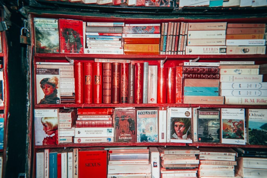 Bookshelves packed with books like fourth wing, some with red spines