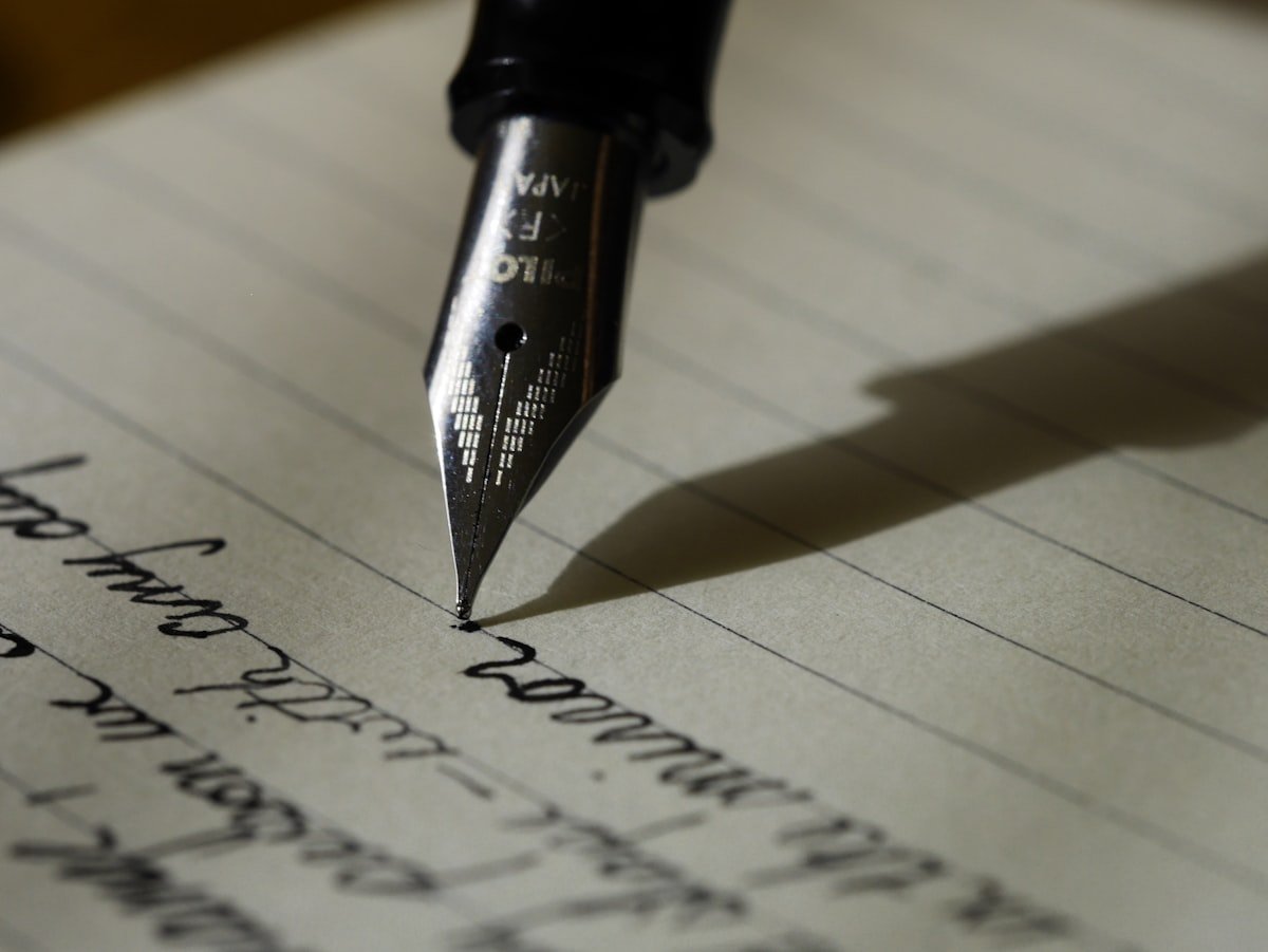Thoughtful Book Gifts for Special Occasions 7 A fountain pen writing on lined paper, for a handwritten book inscription