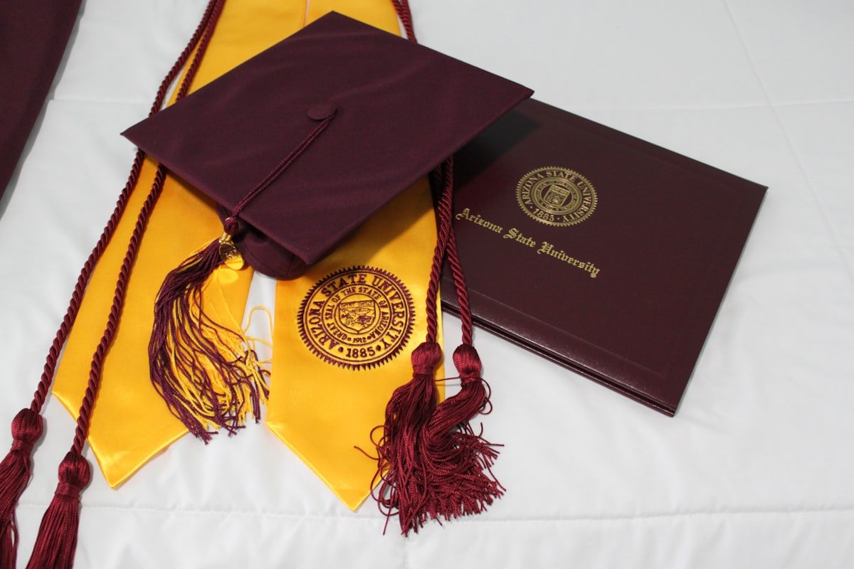 Thoughtful Book Gifts for Special Occasions 2 Black academic graduation cap resting on yellow fabric