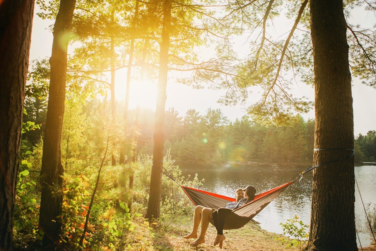 Thoughtful Book Gifts for Special Occasions 6 A couple relaxing in a hammock outdoors surrounded by trees