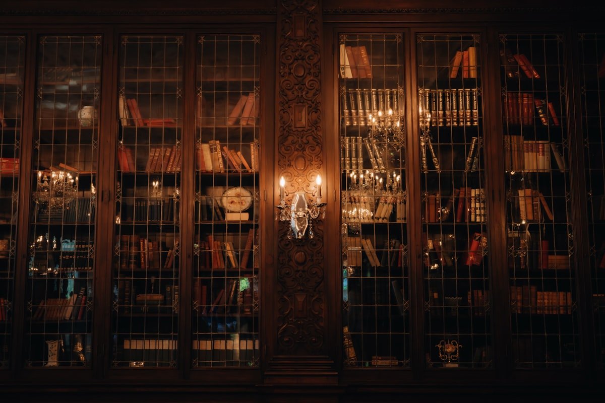 A room filled with rows of books and a chandelier