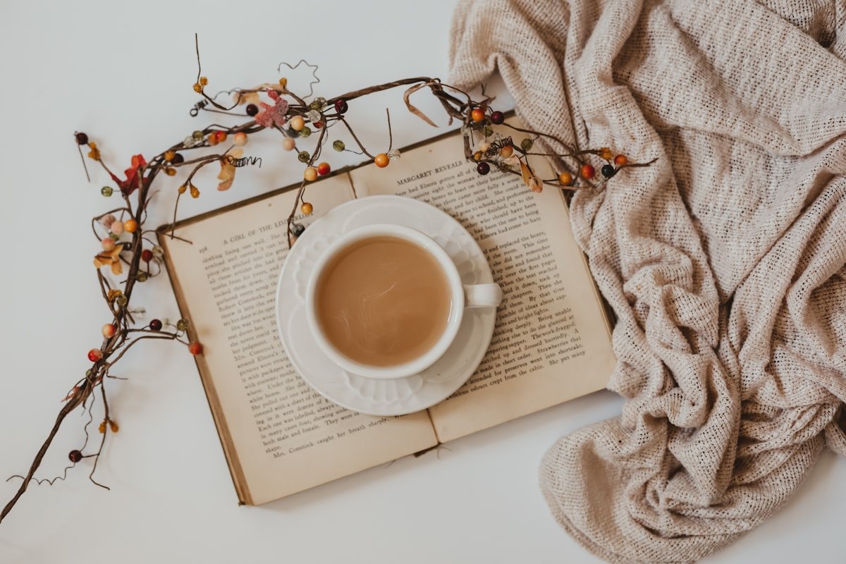Thoughtful Book Gifts for Special Occasions 5 A white ceramic mug resting on an open book, a quiet comfort scene