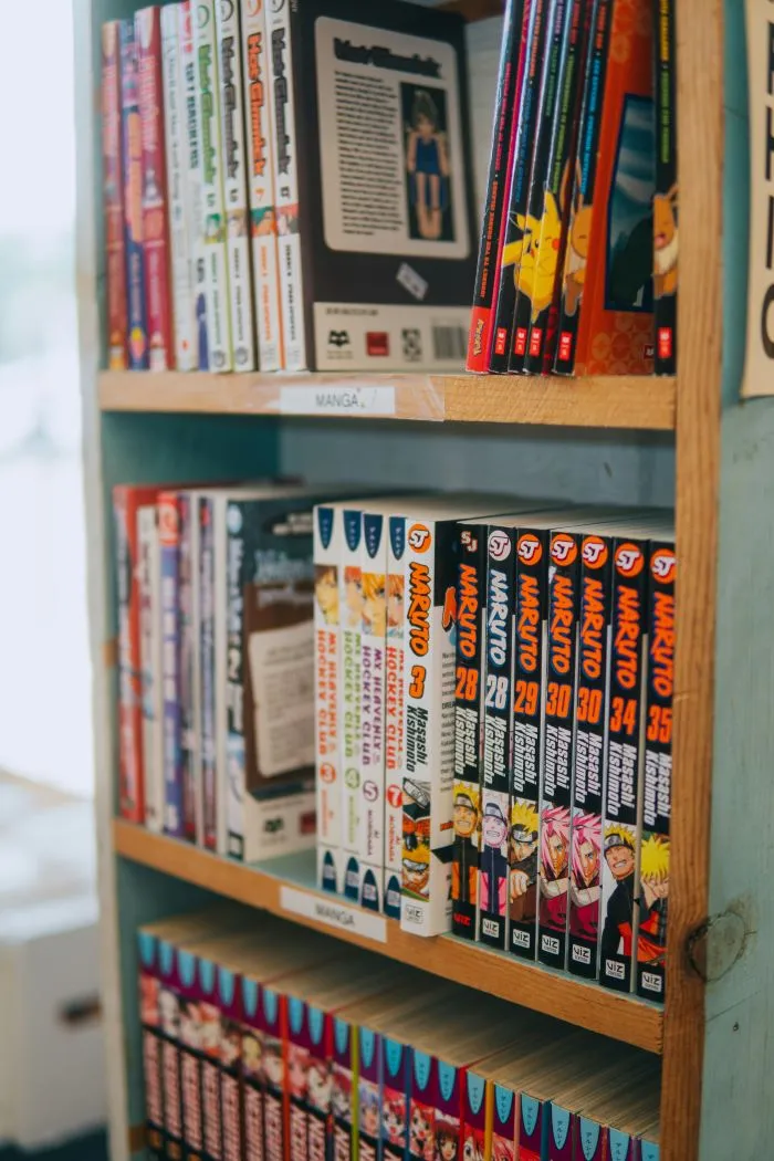 Bookshelf displaying popular manga and graphic novels, including anime-inspired comic book series for young readers.