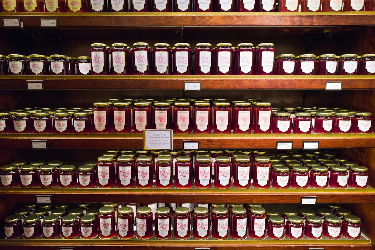 A shelf filled with lots of jars of jam